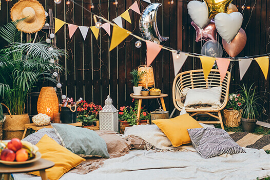 Bunting and scattered cushions for outdoor party decorations